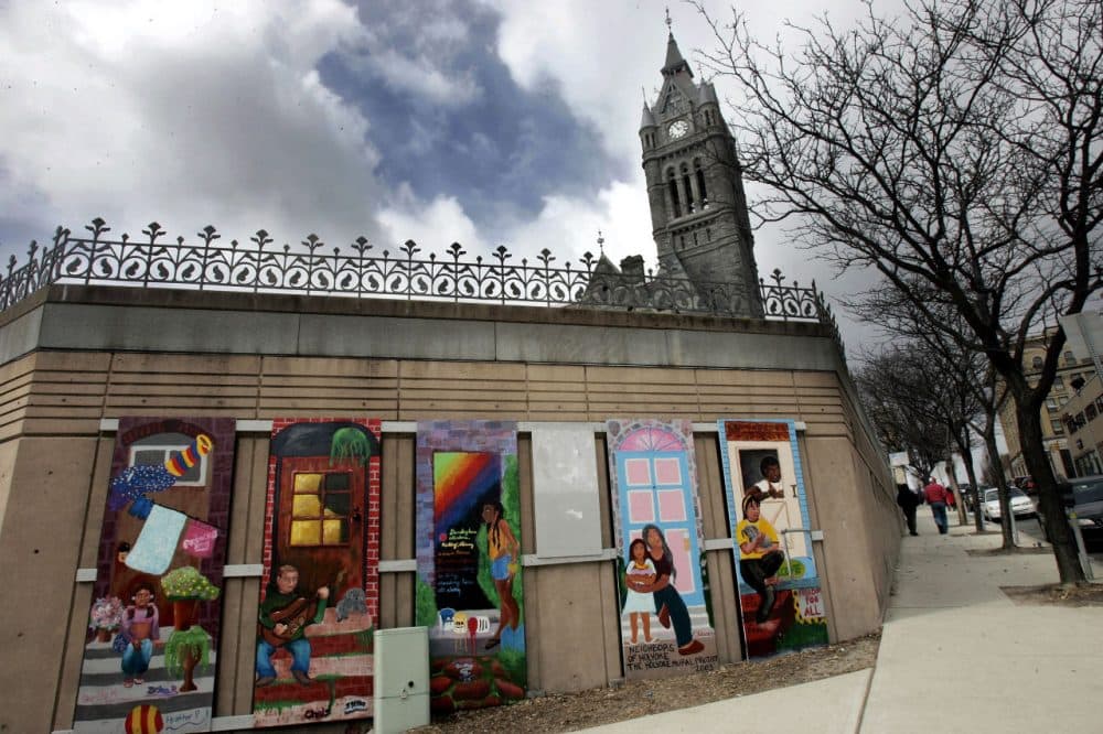 A mural titled, &quot;Neighbors of Holyoke&quot; in front of City Hall's spire, background in Holyoke. (Chitose Suzuki/AP)