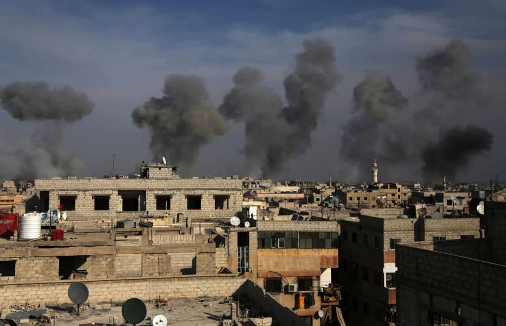 Smoke billows after air strikes by regime forces on the town of Douma in the eastern Ghouta region on Dec. 13, 2015. (Amer Almohibany/AFP/Getty Images)