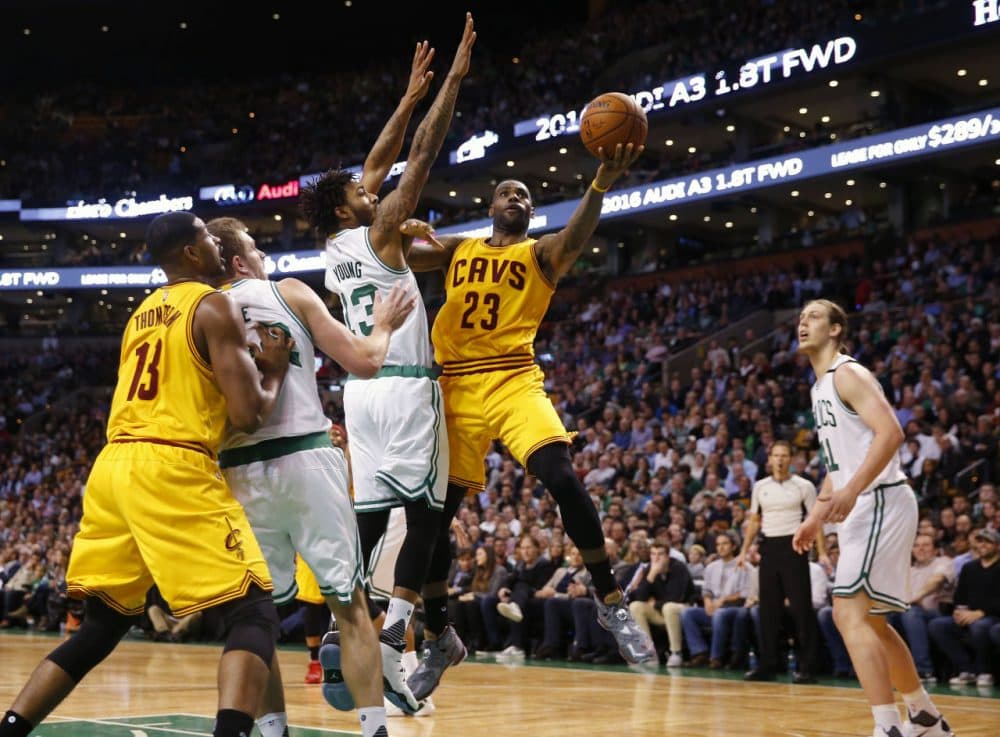 Cleveland Cavaliers' LeBron James goes past Boston Celtics' James Young during the fourth quarter of the Cleveland Cavaliers 89-77 win over the Boston Celtics last night. (Winslow Townson/AP)