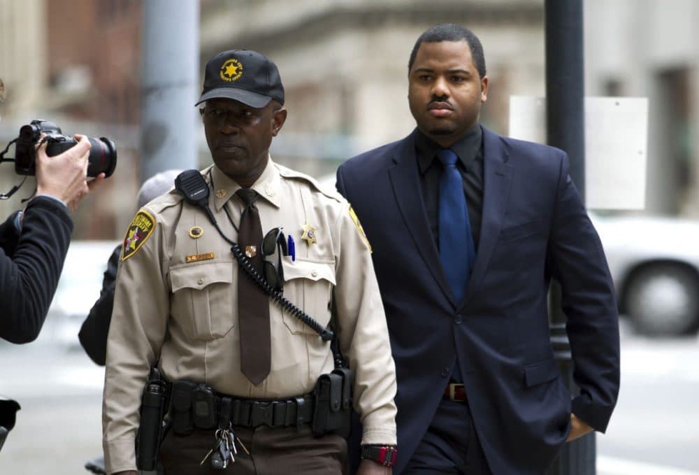 Officer William Porter, right, one of six Baltimore city police officers charged in connection to the death of Freddie Gray, arrives at a courthouse as jury deliberations continue in his trial, Wednesday, Dec. 16, 2015, in Baltimore Md. (Jose Luis Magana/AP)