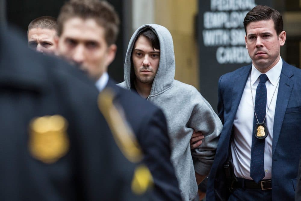 Martin Shkreli (center), then-CEO of Turing Pharmaceuticals, is brought out of 26 Federal Plaza by law enforcement officials after being arrested for securities fraud on December 17 in New York City. (Andrew Burton/Getty Images)