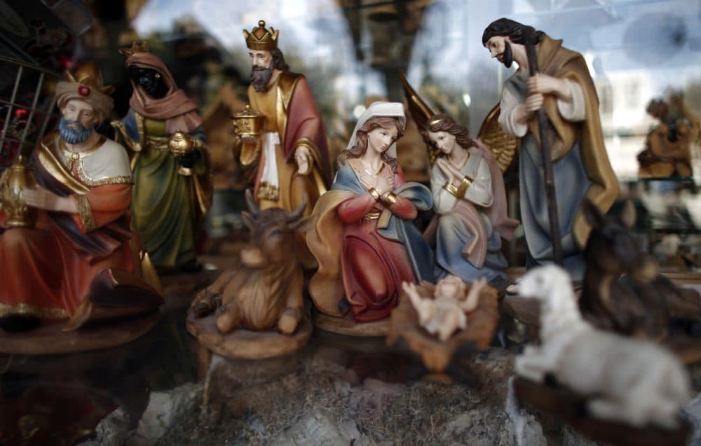 A picture taken on December 16, 2015 in the West Bank city of Bethlehem shows a Christmas manger displayed in front of a Christian souvenir shop on the Manger Square near the Church of the Nativity, revered as the site of Jesus Christ's birth. (Thomas Coex/AFP/Getty Images)