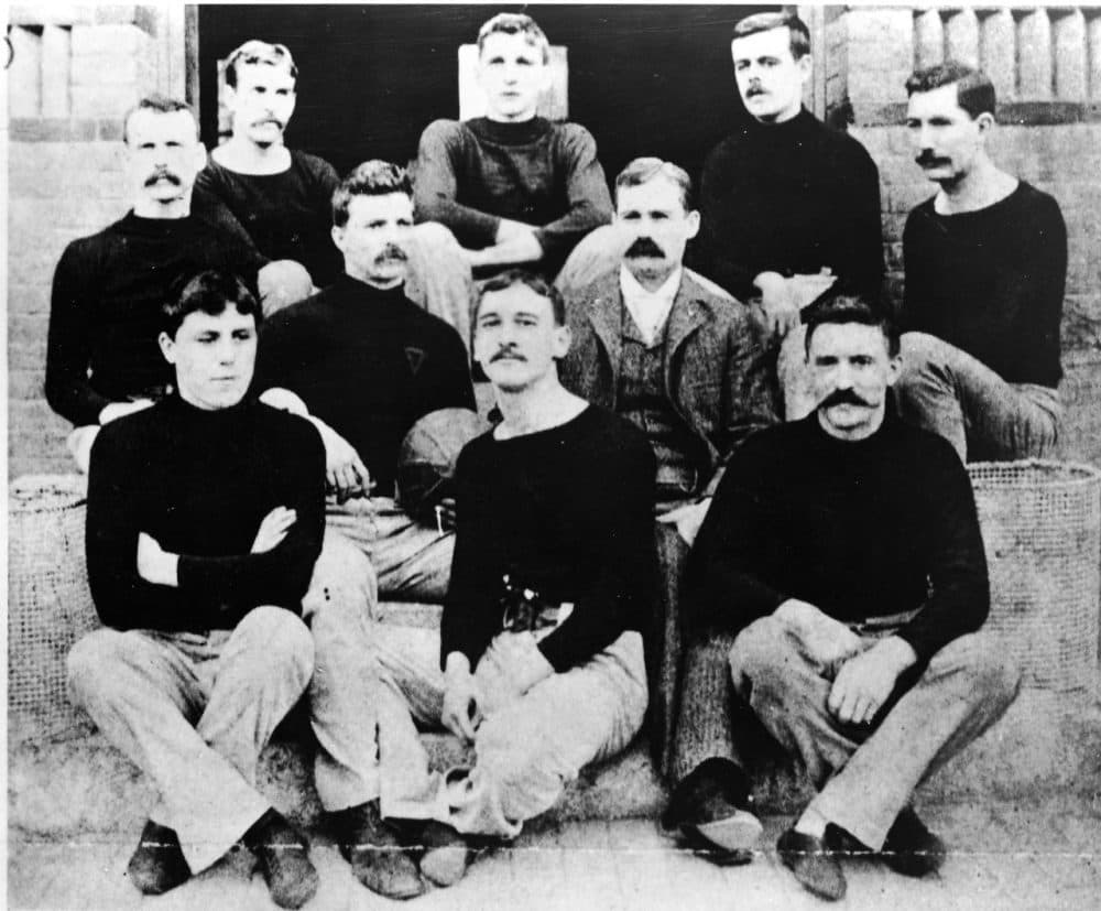 Dr. James Naismith -- the inventor of basketball -- sits with the first team in 1891 in Springfield, Massachusetts. (Hulton Archive/Getty Images)