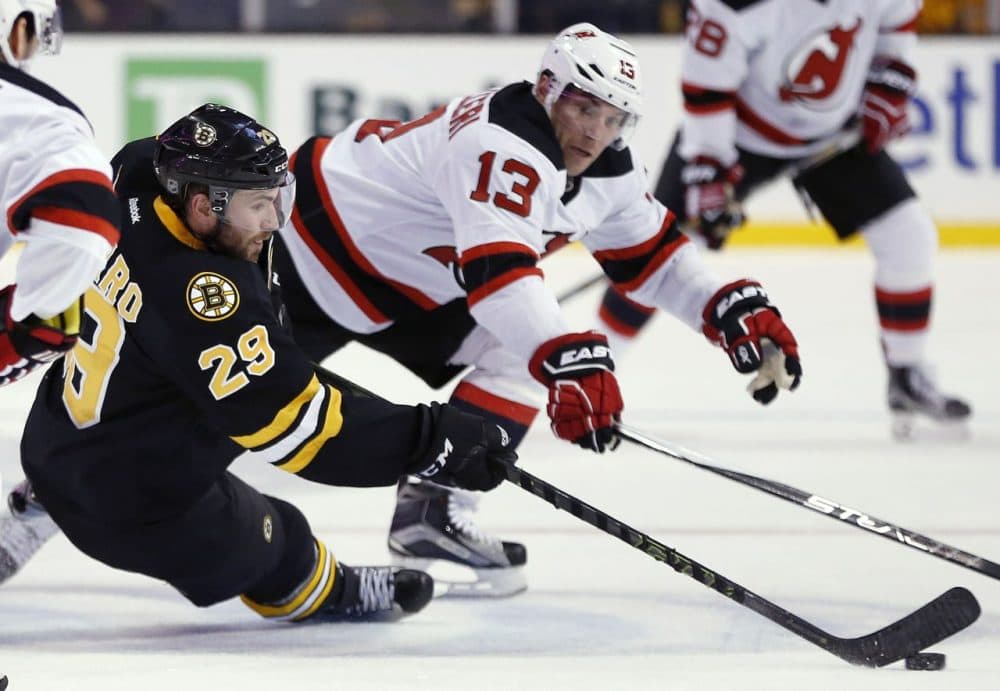 Boston Bruins' Landon Ferraro (29) and New Jersey Devils' Mike Cammalleri (13) battle for the puck during the game yesterday. (Michael Dwyer/AP)