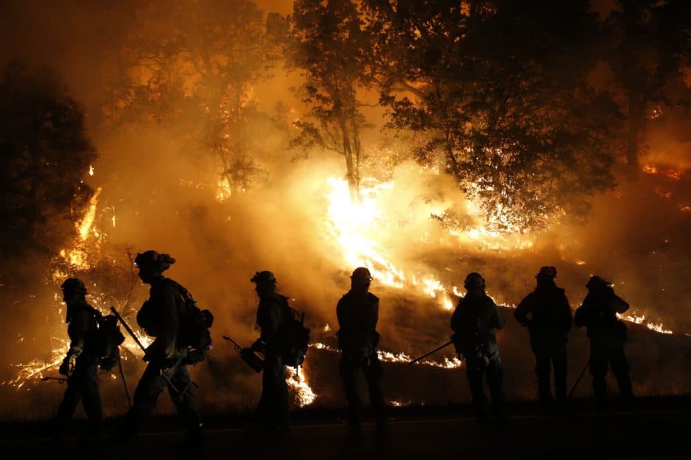 Firefighters with the Marin County Fire Department's Tamalpais Fire Crew monitor a backfire as they battle the Valley Fire on September 13 near Middletown, California. More than 4,000 firefighters from around the country are suing the company that makes sirens on fire trucks for not protecting firefighters' hearing. (Stephen Lam/Getty Images)