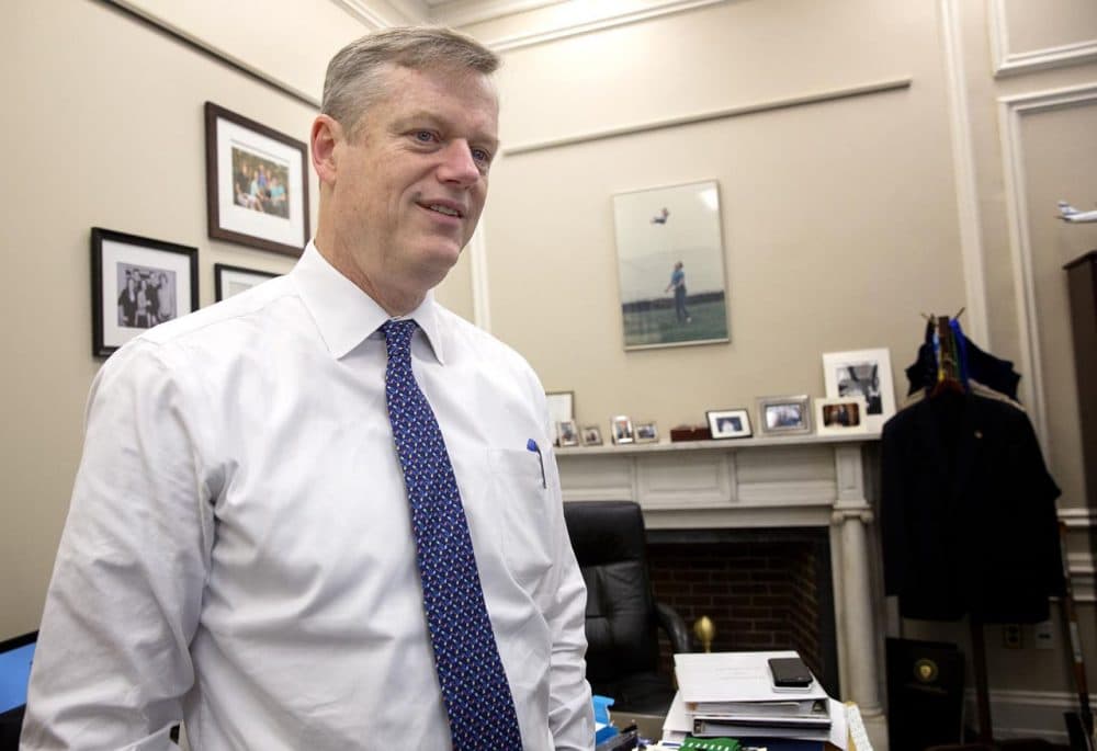 Gov. Charlie Baker, who's ending his first year as governor, is seen in his State House &quot;working office&quot; -- a space covered with family photos and personal memorabilia. (Robin Lubbock/WBUR)