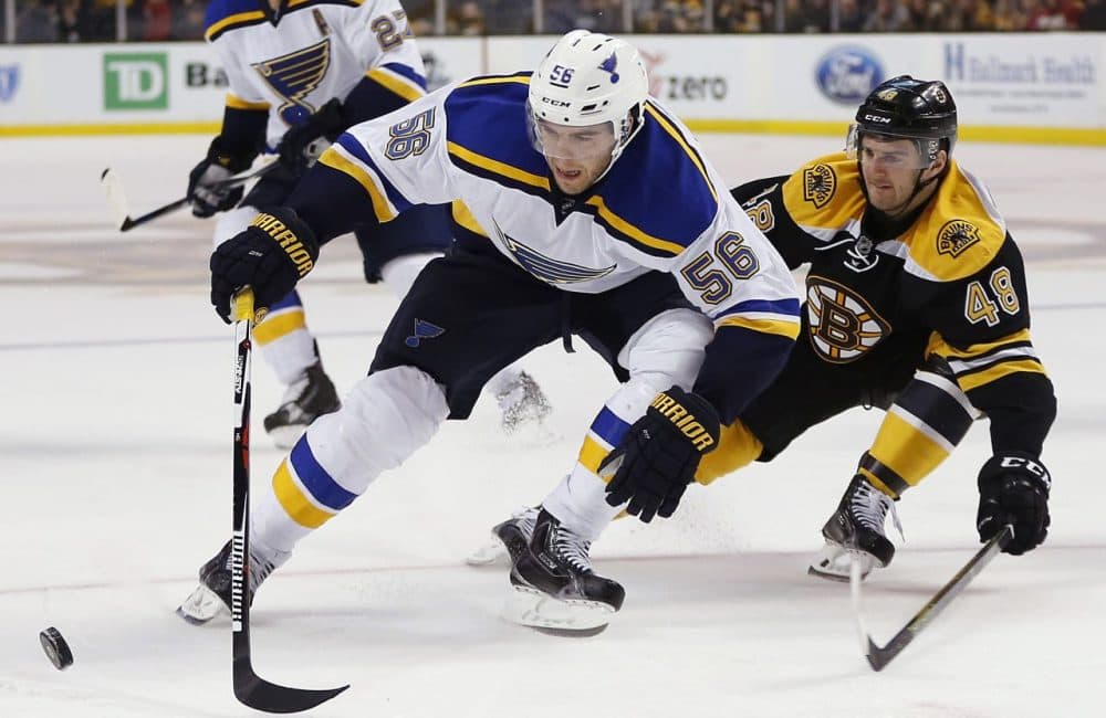 St. Louis Blues' Magnus Paajarvi (56) and Boston Bruins' Colin Miller (48) battle for the puck during the game last night. The Blues won 2-0. (Michael Dwyer/AP)