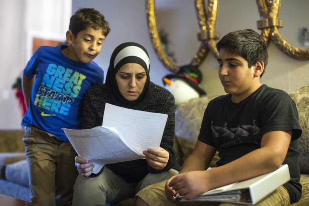 Six days after the San Bernardino shooting, 14-year-old Hassan Messelmani (R) was told by a teacher to &quot;quit acting like a terrorist.&quot; He's shown here with his mother Samira Elzayat and 6-year-old brother Rami. (Maya Sugarman/KPCC)