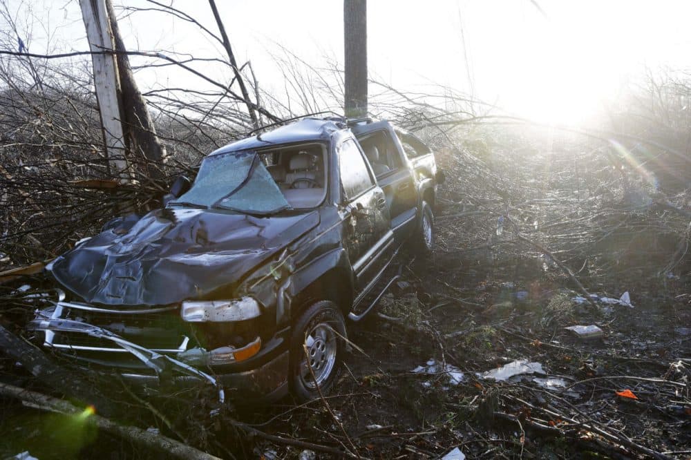 A vehicle sits among debris near the home of Antonio Yzaguirre, 70, and his wife, Ann Yzaguirre, 69, Thursday, Dec. 24 near Linden, Tenn. The couple was found dead after severe storms went through the area Wednesday night. (Mark Humphrey/AP)