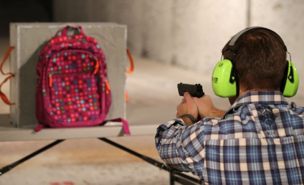 Chief Operating Officer for Amendment II, Rich Brand, shoots a child's backpack with their Rynohide CNT Shield in it on December 21, 2012 in Salt Lake City, Utah. (George Frey/Getty Images)
