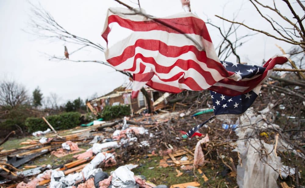 An American flag placed by first responders is seen December 27 in the aftermath of a tornado in Rowlett, Texas. At least 11 people lost their lives as tornadoes tore through Texas, authorities said, as they searched home to home for possible more victims of the freak storms lashing the southern United States. Laura Buckman/AFP/Getty Images)