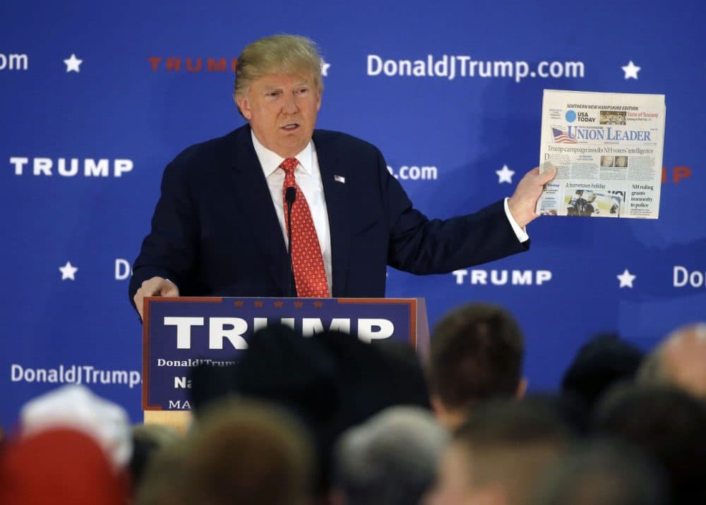 Republican presidential candidate Donald Trump displays a copy of the Union Leader newspaper while addressing an audience during a campaign event Monday, Dec. 28, 2015, in Nashua, N.H. New Hampshire's largest newspaper, the Union Leader, is the latest target of Trump's attacks against the news media. (/Steven Senne/AP)