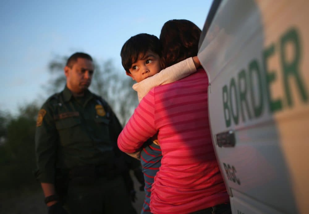 A one-year-old from El Salvador clings to his mother after she turned themselves in to Border Patrol agents on December 7 near Rio Grande City, Texas. The mother said she brought her son on the 24-day journey from El Salvador to escape violence in the Central American country. (John Moore/Getty Images)