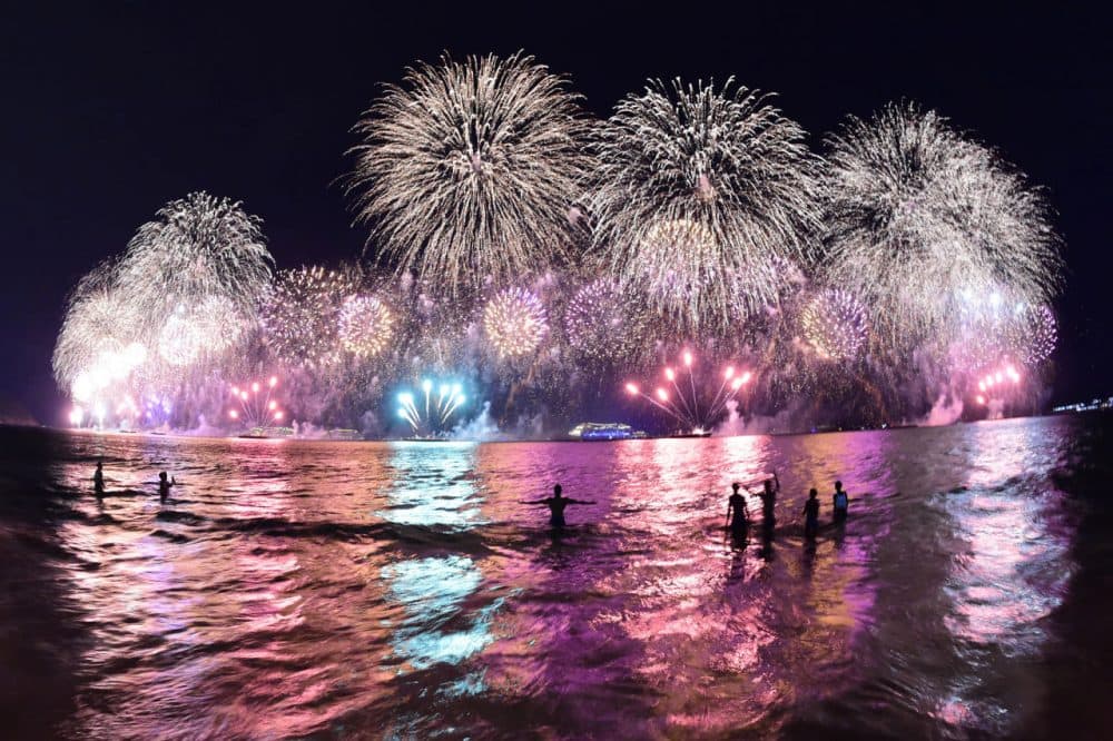 People take a dip in the sea during the fireworks for the new year on Copacabana beach in Rio de Janeiro on January 1, 2015. (Christophe Simon/AFP/Getty Images)