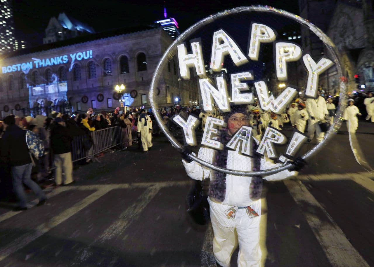 This Dec. 31, 2013, file photo shows marchers making their way down Boylston Street during a parade as part of New Year's Eve celebrations in Boston. (Michael Dwyer/AP)