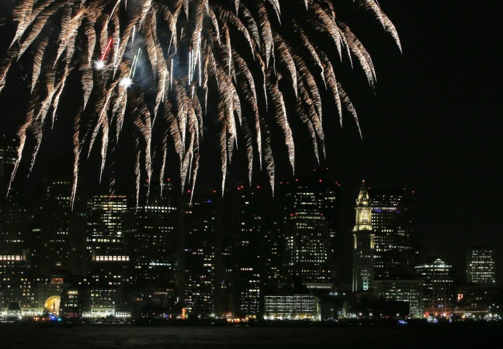 This Jan. 1, 2014, file photo shows fireworks lighting up the sky over Boston Harbor to celebrate First Night in Boston, during New Year's celebrations. (Elise Amendola/AP)