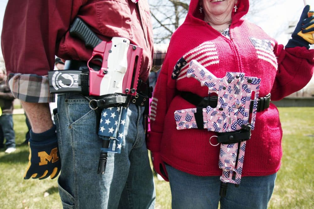 Chris (right) and Marty Welch of Cadillac, Michigan, carry decorated Olympic Arms .223 pistols at a rally for supporters of Michigan's Open Carry law April 27, 2014 in Romulus, Michigan. The march was held to attempt to demonstrate to the general public what the typical open carrier is like. (Bill Pugliano/Getty Images)