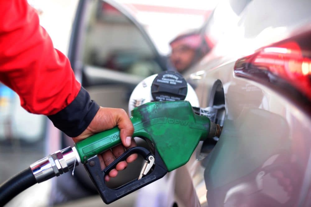 A Saudi employee fills the tank of his car with petrol at a station on December 28 in the Red Sea city of Jeddah. Saudi Arabia said it plans to review the prices of heavily-subsidised power and fuel as part of new measures introduced in the face of low oil prices.   (Amer Hilabi/AFP/Getty Images)