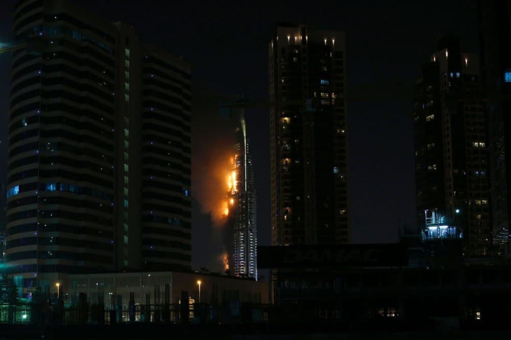 Flames rip through the Address Downtown hotel after it was hit by a massive fire, near the world's tallest tower, Burj Khalifa, in Dubai, on December 31, 2015. People were gathering to watch New Year's Eve celebrations when the hotel caught on fire, with the cause of the blaze still unknown according to the emirate's police chief. (Karim Sahib/AFP/Getty Images)