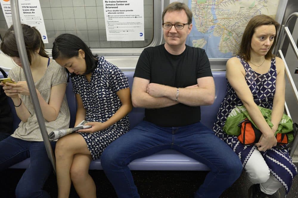 WNYC employees demonstrate &quot;manspreading,&quot; which refers to how men often take up too much space on public transportation. (Richard Yeh/WNYC)
