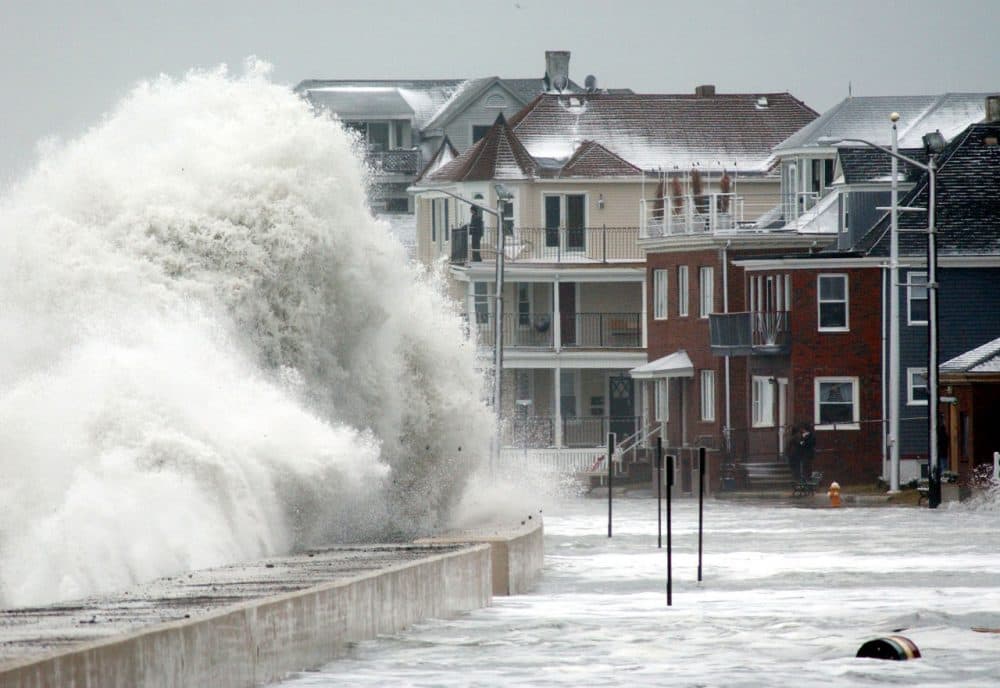 Waves crash over the sea wall in Winthrop, Mass., Saturday, Jan. 4, 2003. Roadways in several coastal communities from Marblehead to Scituate, Mass.,  were closed off and several families were evacuated, as unusually high tidal waves crashed on the shore. (AP Photo/Michael Dwyer)