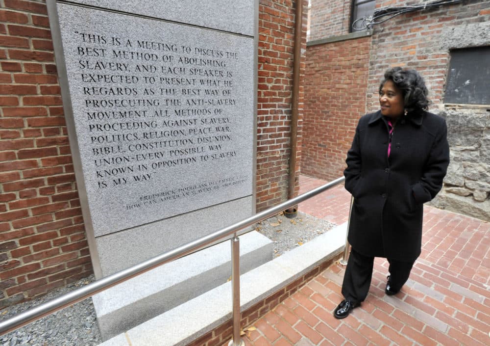 In this file photo, Museum of African American History executive director Beverly Morgan-Welch, walks past a quote from social reformer, statesman, orator and writer Frederick Douglass on a newly constructed entrance to the African Meeting House in Boston. (Josh Reynolds/AP)
