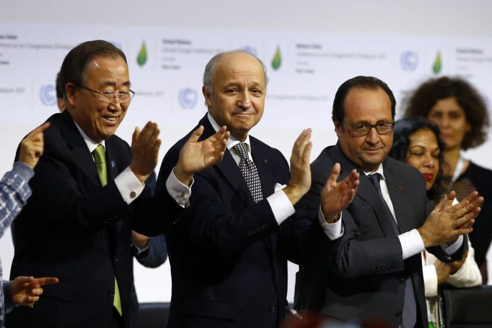 French President Francois Hollande, right, French Foreign Minister and president of the COP21 Laurent Fabius, center, and United Nations Secretary General Ban Ki-moon applaud after the final conference at the COP21, the United Nations conference on climate change, in Le Bourget, north of Paris, Saturday. (Francois Mori/AP)