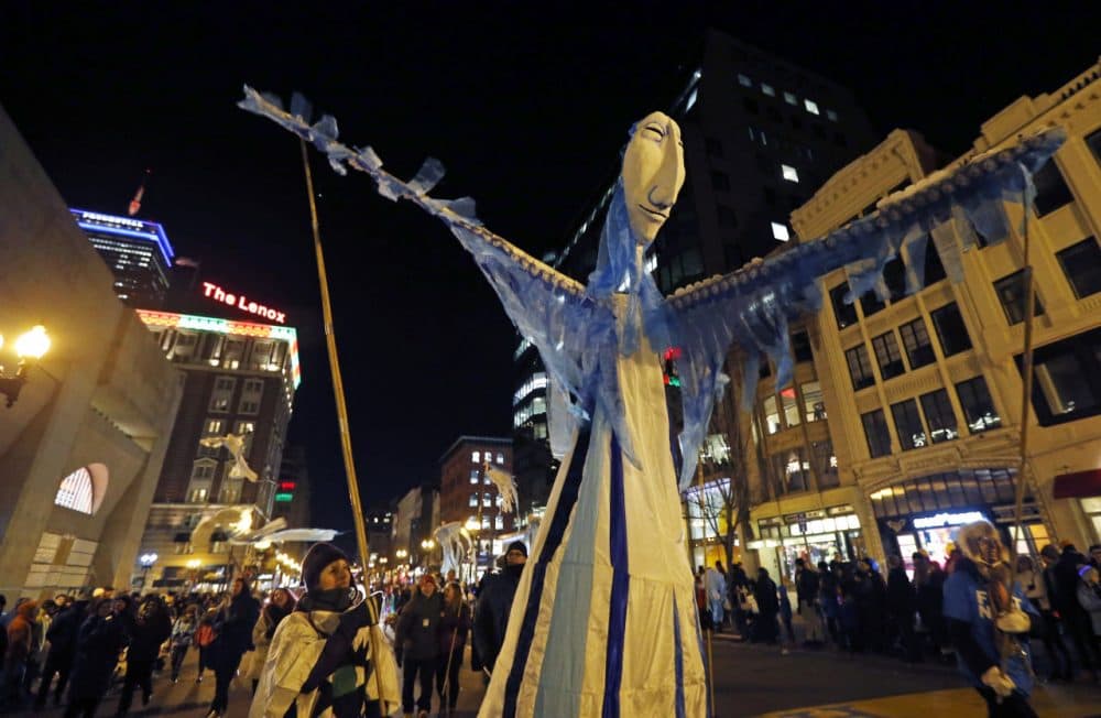 A large puppet makes her way down Boylston Street in the First Night parade during New Years Eve festivities in Bostons Copley Square, Wednesday, Dec. 31, 2014. (Elise Amendola/AP)