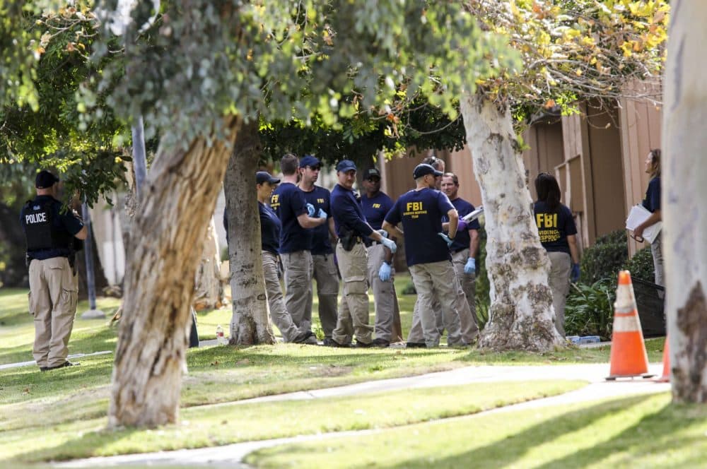 FBI agents search outside a home in connection to the shootings in San Bernardino, Thursday, in Redlands, California. (Ringo H.W. Chiu/AP)