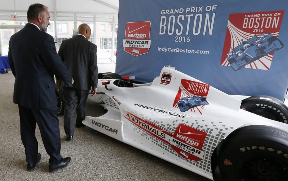 City of Boston Chief of Economic Development John Barros (right) and Tourism, Sports and Entertainment director Ken Brissette (left) examine an IndyCar mock-up in May 2015. (Michael Dwyer/AP)