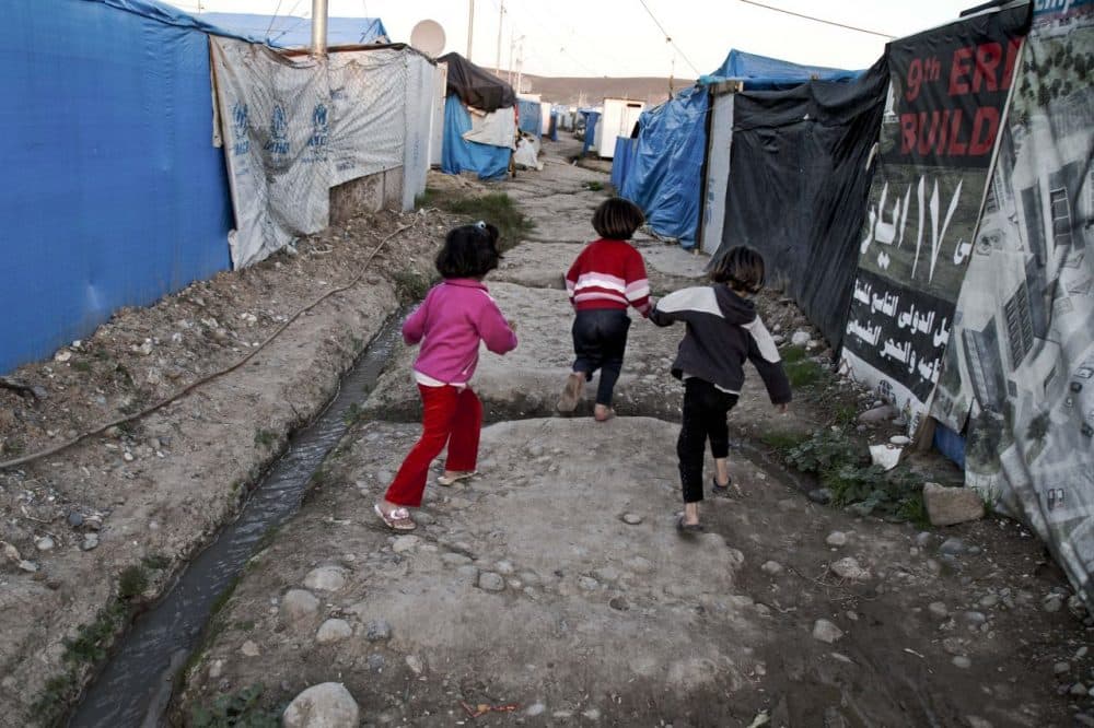 Syrian refugee children run at a temporary refugee camp on Nov. 28 in Irbil, Iraq. (Seivan M. Salim/AP)