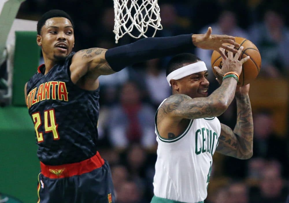 Atlanta Hawks' Kent Bazemore blocks a shot by Celtics' Isaiah Thomas during the first quarter the game in Boston Friday night. (Michael Dwyer/AP)