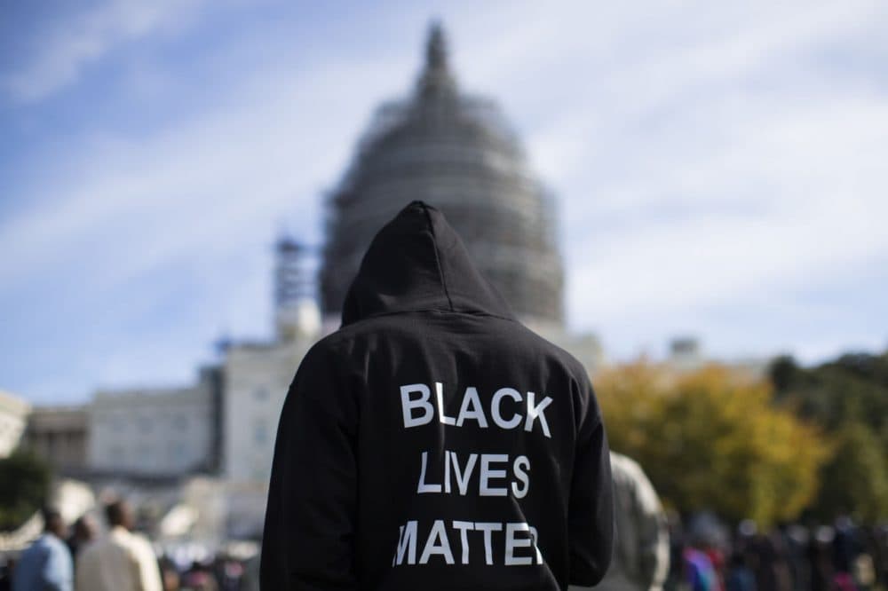 Neal Blair, of Augusta, Ga., wears a hoodie which reads, &quot;Black Lives Matter&quot; as stands on the lawn of the Capitol building during a rally to mark the 20th anniversary of the Million Man March, on Capitol Hill, on Saturday, Oct. 10, 2015, in Washington. Black men from around the nation returned to the capital calling for changes in policing and in black communities. (AP Photo/Evan Vucci)
