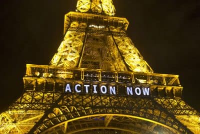 In this Sunday, Dec. 6, 2015, photo, the Eiffel Tower lights up with the slogan&quot;Action Now&quot;referring to the COP21, United Nations Climate Change Conference in Paris. The carbon footprint for the COP21 conference runs to thousands of tons, for the some 40,000 people, including heads of state, negotiators, activists and journalists, in Paris to hash out a ground-breaking international agreement to put a brake on global warming. (AP Photo/Michel Euler)