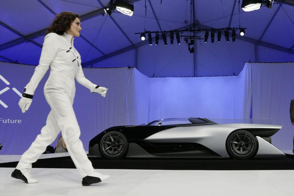 A driver walks in front of the FFZero1 by Faraday Future at CES Unveiled, a media preview event for CES International, on Monday, Jan. 4, 2016, in Las Vegas. The high-performance electric concept car was unveiled during a news conference by Faraday Future. (Gregory Bull/AP)