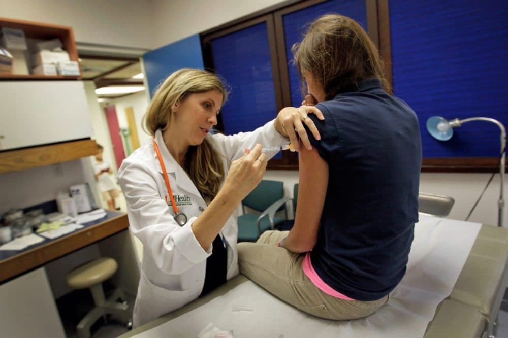 University of Miami pediatrician Judith L. Schaechter, M.D. (L) gives an HPV vaccination to a 13-year-old girl in her office at the Miller School of Medicine on September 21, 2011 in Miami, Florida. (Joe Raedle/Getty Images)