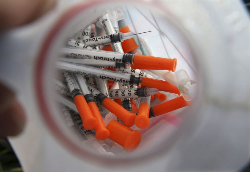 A jug of used needles to exchange for new in an industrial area of Camden, N.J. (Mel Evans/AP)