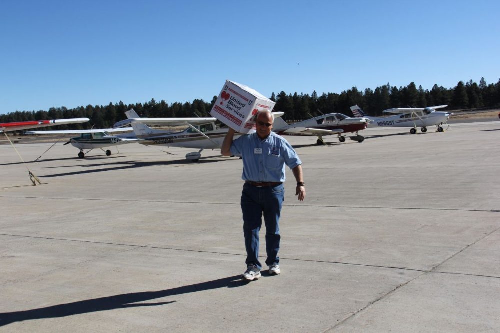Paul Rowley delivers a box of platelets to the Flagstaff Pulliam airport to then be picked up by a local hospital. (Chloe Nordquist/KJZZ News)