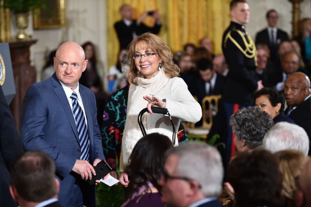 Former congresswoman and gun violence survivor Gabrielle Giffords (center) and her husband astronaut Mark Kelly (left) arrive to hear President Barack Obama speak on reducing gun violence in the East Room of the White House on January 5, 2016 in Washington, D.C. (Mandel Ngan/AFP/Getty Images)