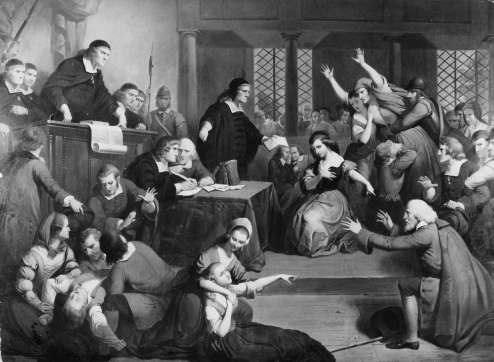 In this image, people faint and cause disorder in a courtroom during the 1692 trial of suspected witch, George Jacobs. (Douglas Grundy/Three Lions/Getty Images)