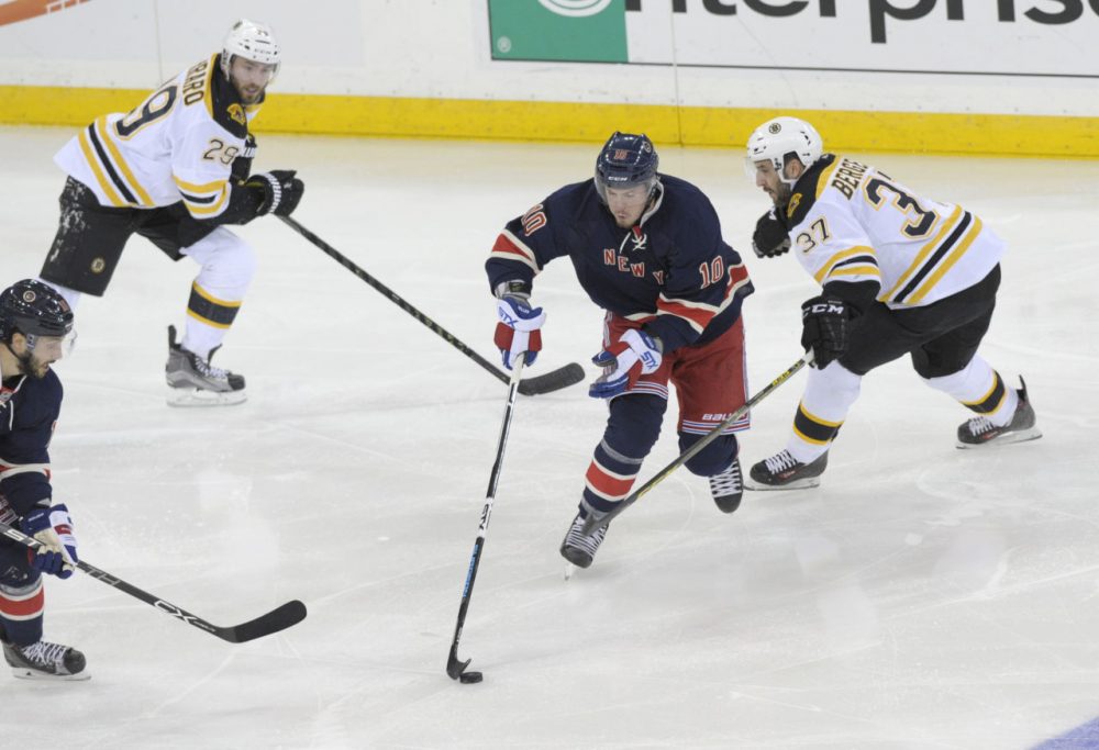 Rangers' J.T. Miller skates between Bruins' Patrice Bergeron, right, and Landon Ferraro, left, during the third period of a game Monday, at Madison Square Garden. (Bill Kostroun/AP)
