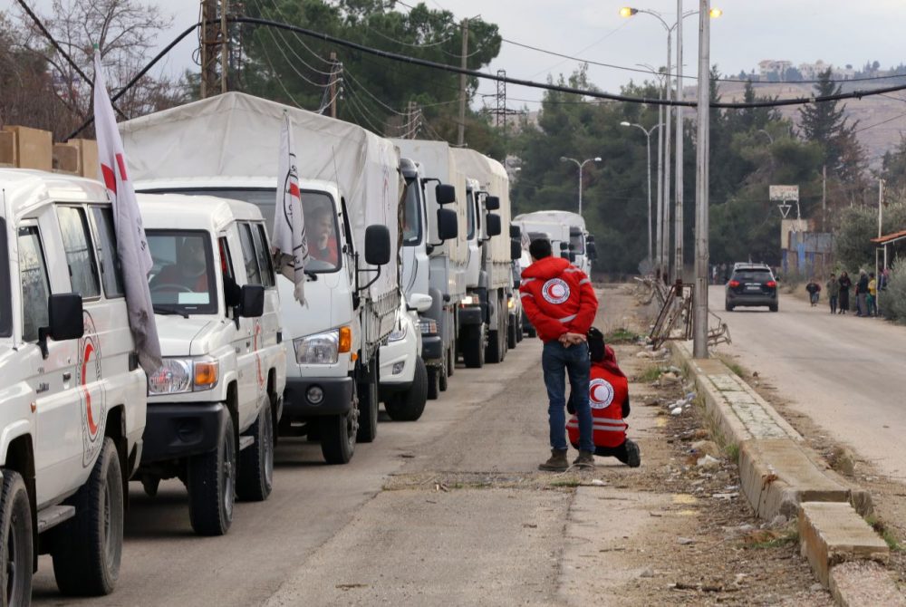 A convoy of aid from the International Committee of the Red Cross (ICRC) waits on the outskirts of the besieged rebel-held Syrian town of Madaya, on January 11, 2016. 
Dozens of aid trucks headed to Madaya, where more than two dozen people are reported to have starved to death, after an outpouring of international concern and condemnation over the dire conditions in the town, where some 42,000 people are living under a government siege.
 (Louai Beshara/AFP/Getty Images)