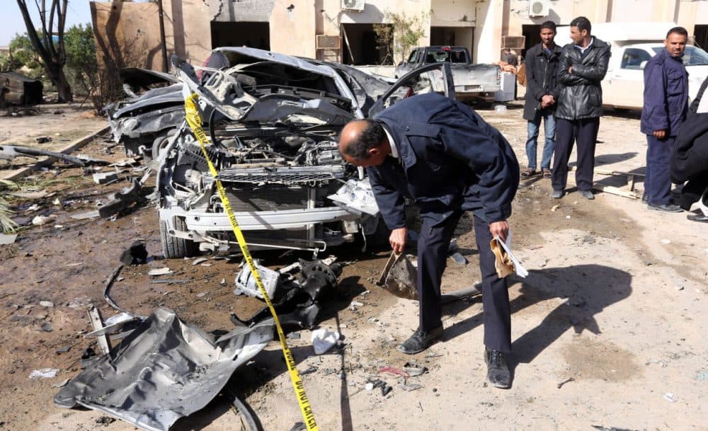 Libyan security forces inpect damaged cars at the site of a suicide truck bombing on a police school in Libya's coastal city of Zliten, some 170 kilometres (100 miles) east of the capital Tripoli, which killed at least 50 people on January 7, 2016, in the deadliest attack to hit the strife-torn country since its 2011 revolution. (Mahmud Turkia/AFP/Getty Images)