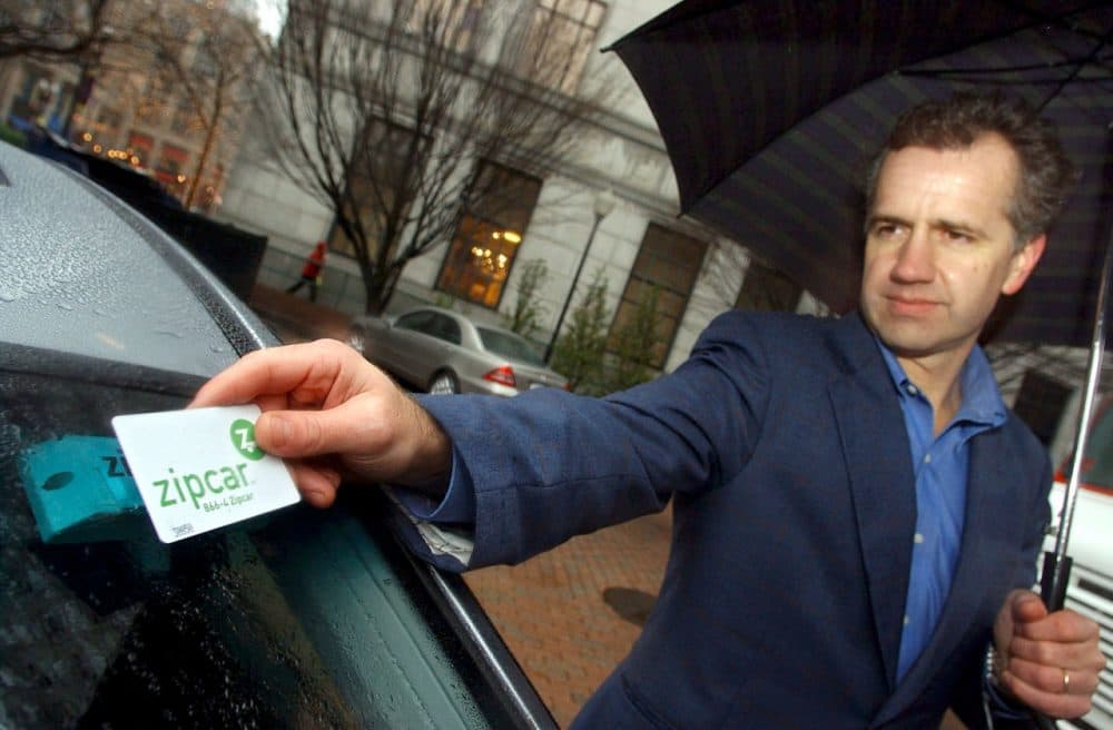 Clark Waterfall of Hopkinton unlocks his Zipcar in Boston. In &quot;Sharing Cities,&quot; Julian Agyeman argues we can move beyond just a sharing economy, to share more broadly in our communities. (Lisa Poole/AP)