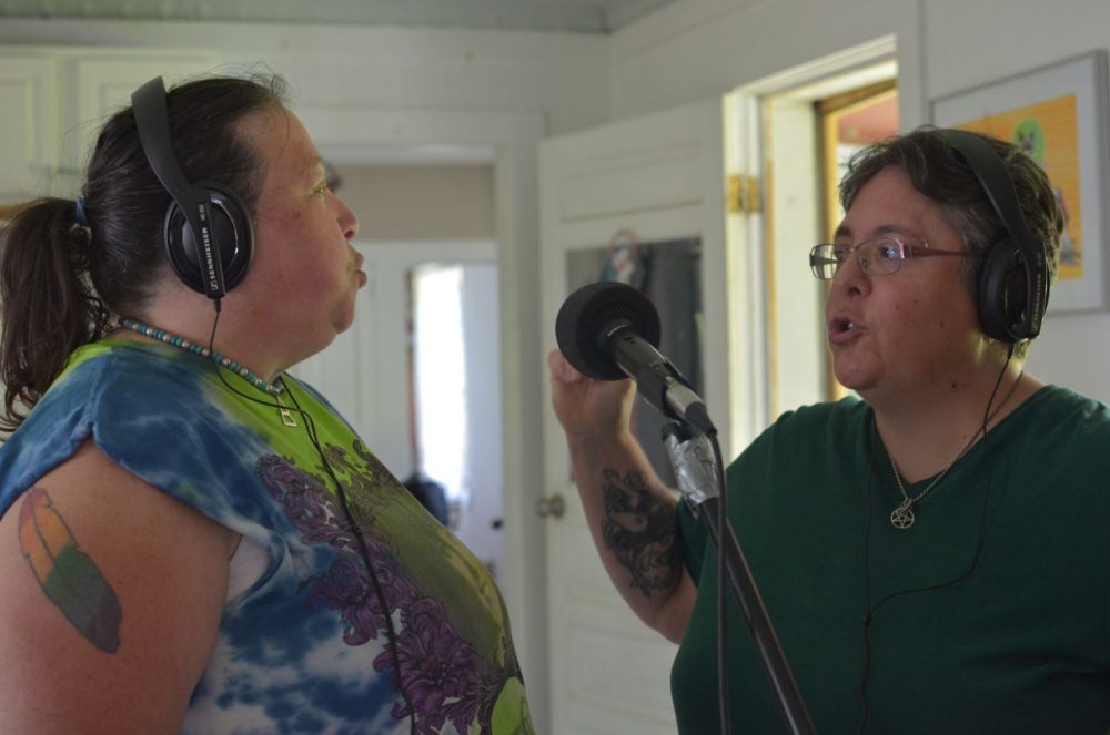 The nonprofit &quot;Songbird Sings&quot; facilitates songwriting workshops, where women discuss their experiences with trauma and then create music. At a workshop in Shelburne Falls, Sherri Healy, left, and Laurie Batog, right, add backing vocals to a song. (Sharon Brody/WBUR)
