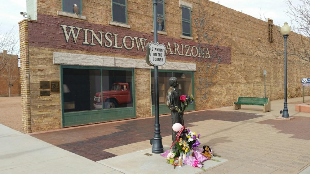The corner in Winslow, Arizona, made famous by the 1972 Eagles' song &quot;Take it Easy,&quot; is pictured on Jan. 19, 2016. Fans are leaving flowers, hand-written notes and candles at the site to celebrate the life of Eagles band member Glenn Frey, who died Monday at 67. (Tom McCauley via AP)