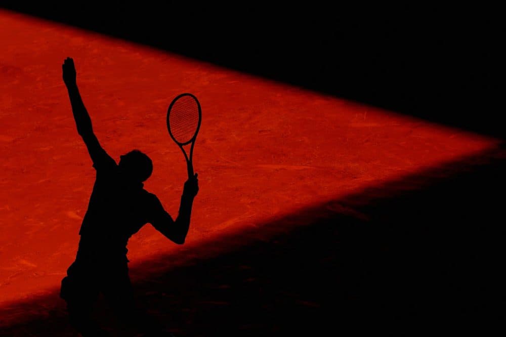 A silhouette of a tennis player serving. (Julian Finney/Getty Images)