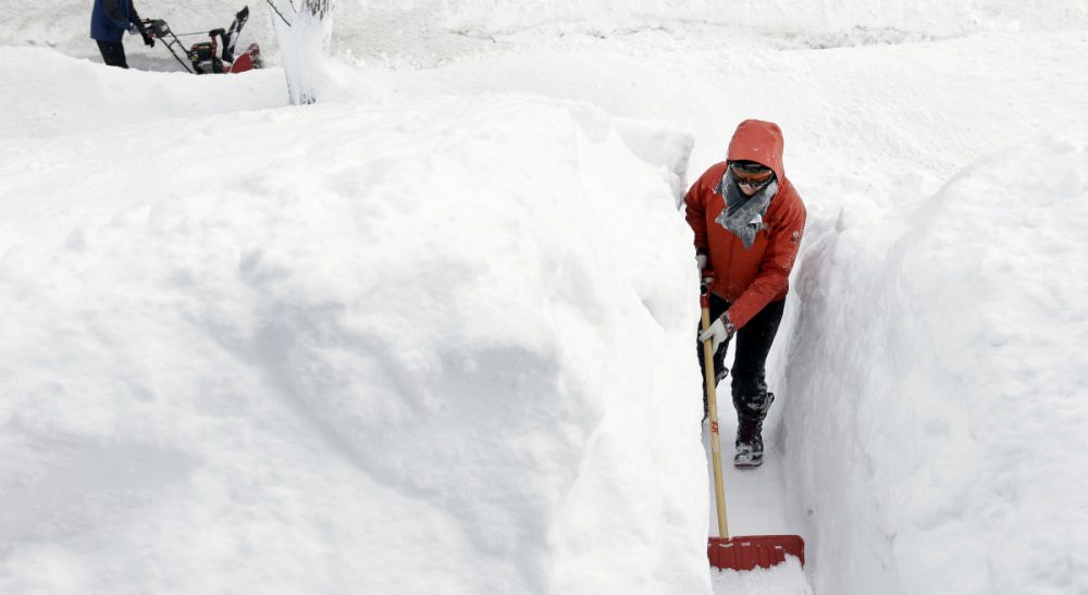 Julie Wittes Schlack: Mathematical uncertainty hasn’t prevented me and everyone I know from obsessing over the mere possibility of a blizzard. In this photo from last winter, a woman shovels a path in the snow in front of her Norwood, Mass., home. (Steven Senne/AP)
