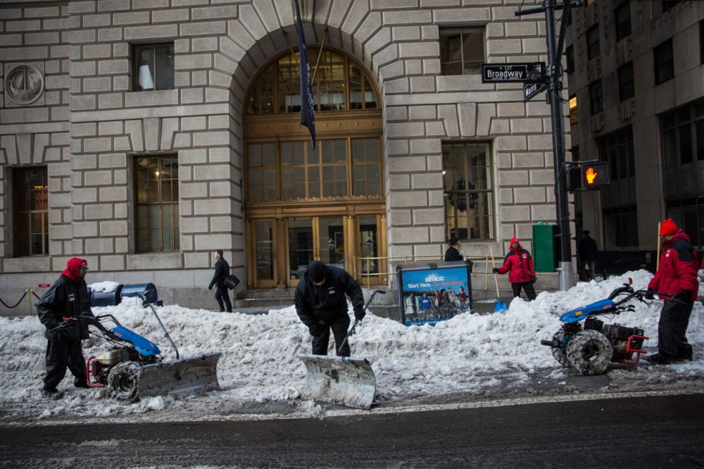 Workers clear the street of snow two days after a massive snowstorm covered the East Coast of the United States in snow on January 25, 2016 in New York City. (Andrew Burton/Getty Images)