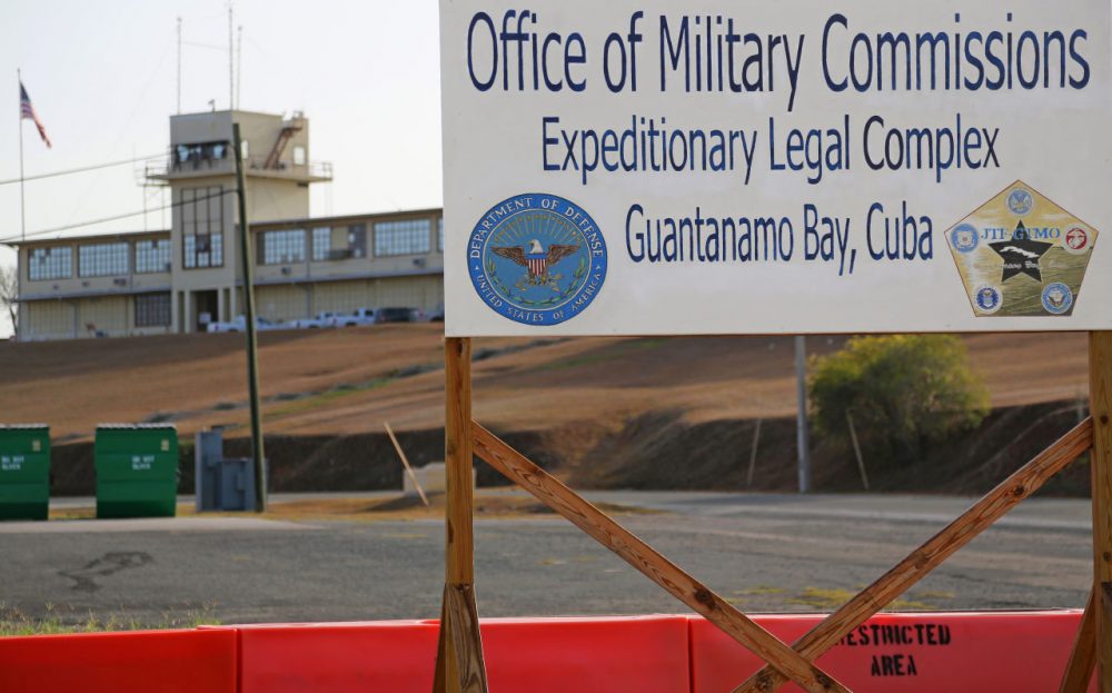 This June 17, 2013, photo shows a sign outside the Courthouse One Expeditionary Legal Complex at Naval Station Guantanamo Bay, Cuba. U.S. prosecutors are asking a military judge to reconsider his decision to try one of the men accused of plotting the Sept. 11 attack apart from the other four. Prosecutors have asked Army Col. James Pohl to hear arguments on their emergency motion involving Binalshibh first thing Monday, Aug. 11, 2014, at a pretrial hearing at the Guantanamo Bay naval base in Cuba. (Bill Gorman/AP)